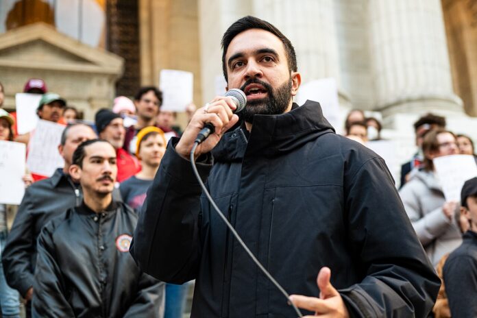 1280px-Zohran_Mamdani_at_the_Resist_Fascism_Rally_in_Bryant_Park_on_Oct_27th_2024 Zohran_Mamdani